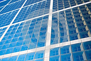 Building facade with blue glass windows. Modern architecture and structure. Construction and design. Commercial property