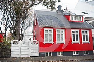 Building facade with red wall and white window frames. Architecture design concept. Scandinavian house design and nordic