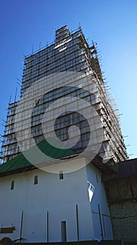 Building facade renovation, scaffolding. Restoration of ancient high house. Renovation and Reconstruction. Revival of architecture