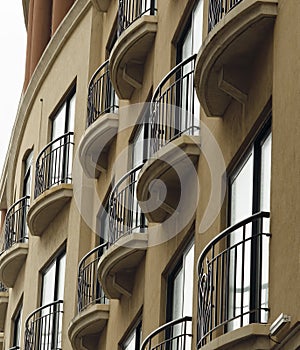 Building Facade With Tall Windows And Wrought Iron Railing Balconies