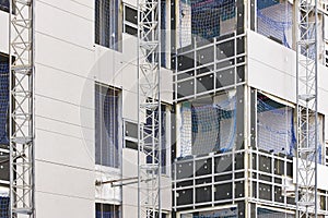 Building facade under construction. Insulation material and tile