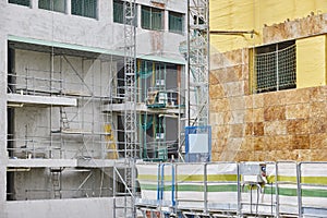 Building facade under construction. Insulation material and tile