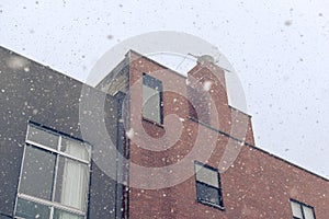 Building facade during very heavy snowfall in Harlem, New York, USA