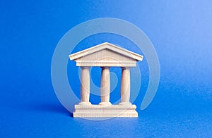 Building figurine with pillars in antique style. Concept of city administration, bank, university, court or library. Architectura photo
