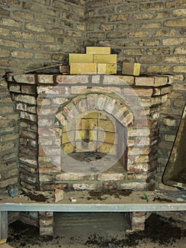 Building a fireplace in a house using old bricks. Beautiful bricklaying