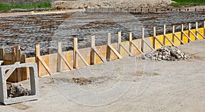 building formwork made with yellow wooden planks during laying cement photo