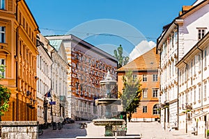 Building and fountain next to fountain novi trg square in Ljubljana