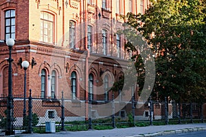 The building has an old red brick facade. Arched windows.