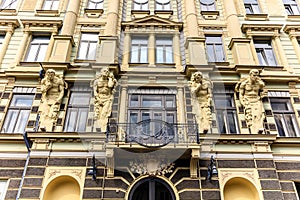 The building has statues of men on the front