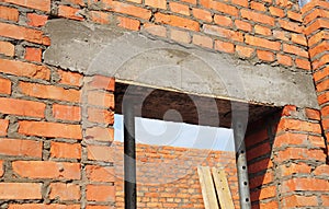 Building house construction. Window, door concrete lintel with iron bar on brick unfinished house construction.