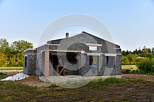 Building a house of expanded-clay concrete blocks. Unfinished private home of ceramsite concrete blocks on a construction site.