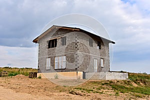 Building a house of expanded-clay concrete blocks. Unfinished private home of ceramsite concrete blocks on a construction site.