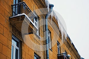 building icicles yellow wall windows sky