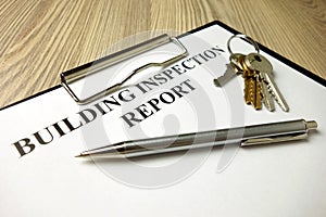 Building inspection report with pen and keys
