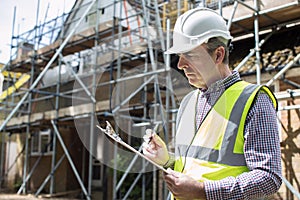 Building Inspector Looking At House Renovation Project