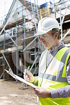 Building Inspector Looking At House Renovation Project