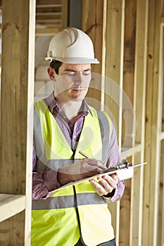 Building Inspector Looking At New Property