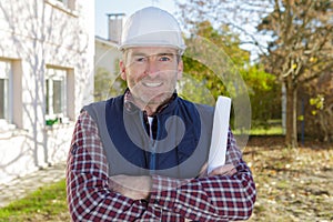 building inspector posing arms crossed at construction site