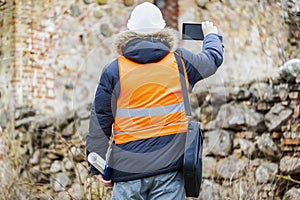 Building inspectors with tablet PC at old ruins