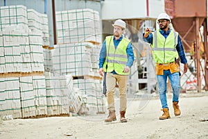 Building inspectors walking on construction site