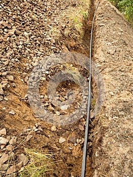 Building of lines of metallic and fiber optic cables. Laying underground tow network connection cable.