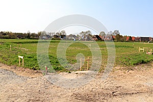 Building lot site with grass after stakeout measurement survey ready for construction, Germany photo