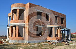 Building luxury residential brick house construction exterior without roofing