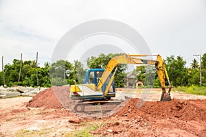 Building Machines: Digger loading trucks with soil. Excavator loading sand into a dump truck.