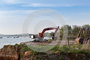 Building Machines: Digger loading trucks with soil. Excavator loading sand into a dump truck.