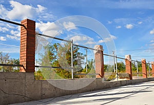 Building a Metal and Concrete, Bricks Fence with Iron Bar Framework