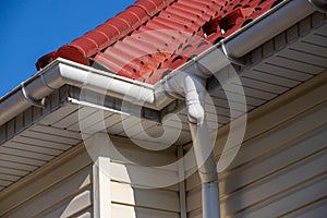 Building Modern House Construction with metal roof corner, rain gutter system and roof protection from snow board, snow
