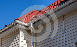 Building Modern House Construction with metal roof corner, rain gutter system and roof protection from snow board, snow