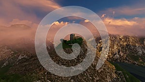 Building On mountaintop at sunset