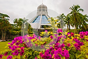 The building is a Museum of cats. Red pink flowers. Kuching, Borneo, Sarawak, Malaysia