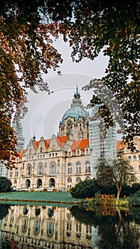 The building of the new city hall in the city of Hannover, Germany, peeping between the trees on an autumn day