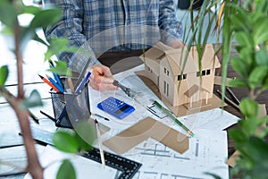 Building new home - design scale model of modern house. Real estate concept