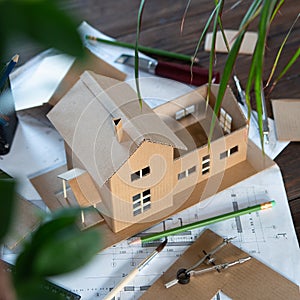 Building new home - design scale model of modern house. Real estate concept