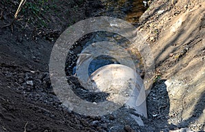 When building a new road, it is necessary to bridge the stream with the help of a metal pipe only for the duration of the construc