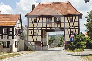 Building over the road in rural Germany village. Old house as ex