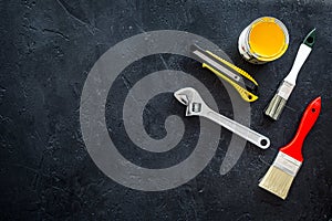 Building, painting and repair tools for house constructor work place set dark background top view space for text