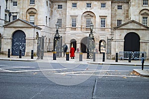 The building of palace and the security guards in red and black uniforms