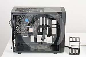 Building of PC, ATX motherboard inserted to black computer midi