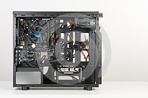 Building of PC, ATX motherboard inserted to black computer midi