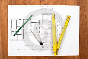 Building plan with pencil, folding yardstick and compass