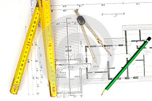 Building plan with pencil, folding yardstick and compass