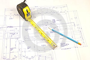 Building plans and tape measure