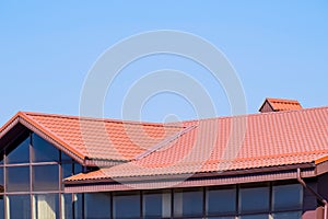 A building with a red-brown . Modern materials of finish and roofing