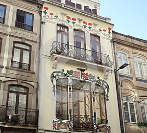 Building with red and green flowers and windows