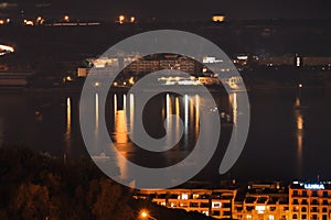 Building and reflection in the water at night