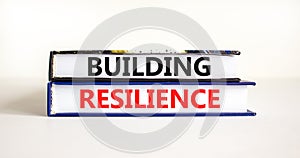 Building resilience symbol. Concept word Building resilience typed on books. Beautiful white table white background. Business and